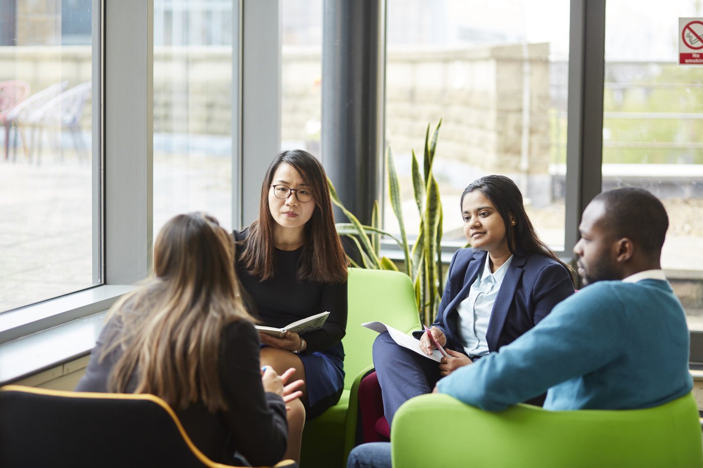 MBA students sitting in a collaborative space.