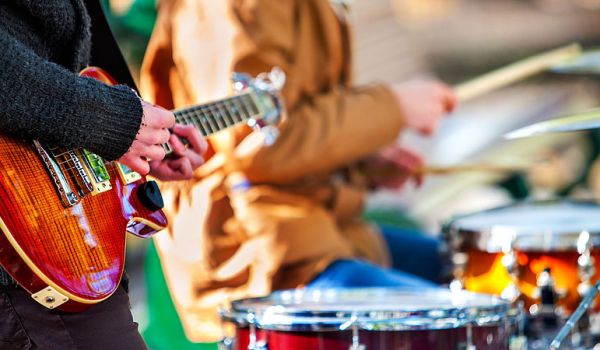 Photograph of a guitarist and a drummer