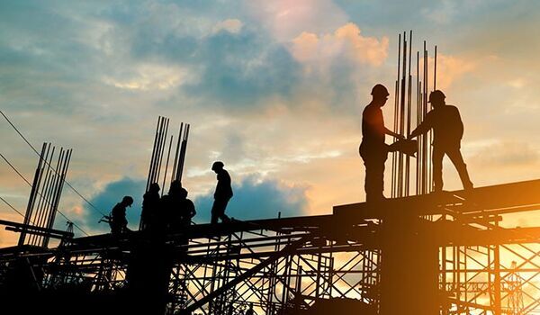 Building contractors working on a steel frame