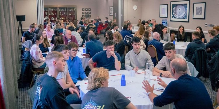 A room full of diverse students and more than 20 influential business leaders