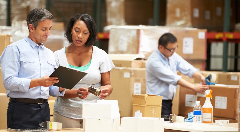 Man and woman looking at a clipboard in a factory