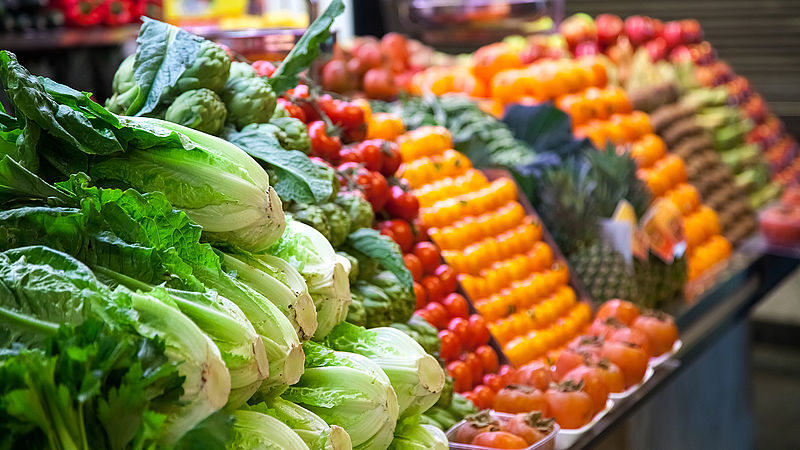 Photograph of a fruit and vegetable stand.