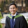 Damien Lee standing on the balcony of the Maurice Keyworth building on his graduation day.