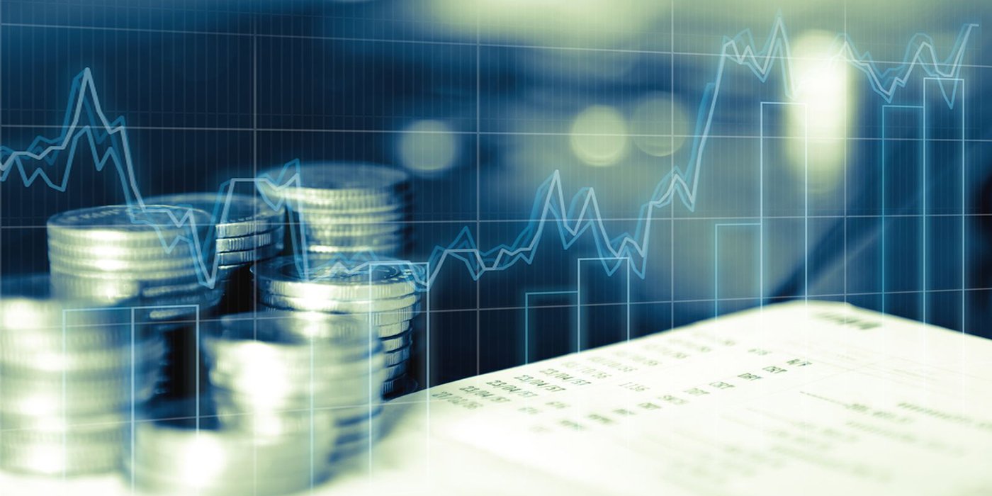 An abstract photo with stacks of coins and graphs