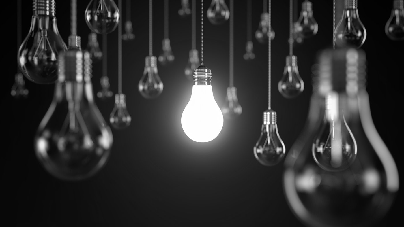 Black and white light bulbs: central bulb is lit