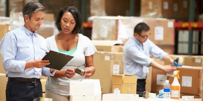 Man and woman looking at a clipboard in a factory