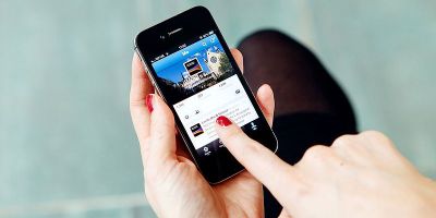Close of a person using a phone to post to social media