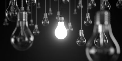 Black and white light bulbs: central bulb is lit