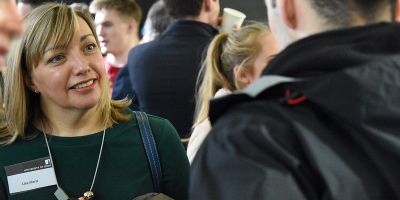 Lisa Florit smiles at an unknown subject, during a busy leaders in residence social event