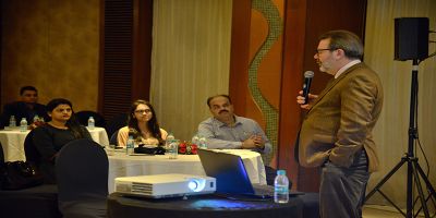 Prof. Gary Dymski speaking at the Mumbai alumni event.