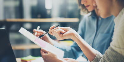 Two business people looking at paper