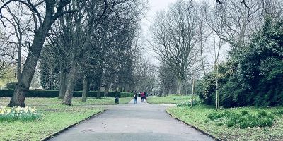 Path in a park with students walking in the distance