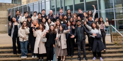 MSc IB Alumni and students on stairs