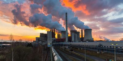 Image of a factory with smoking chimneys