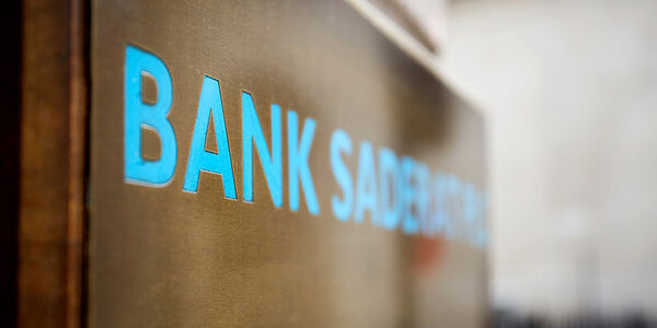A close up of blue signage saying the word 'BANK'