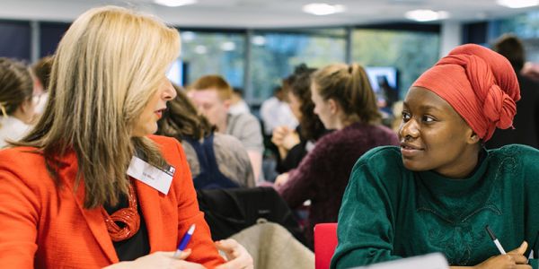 A student receiving guidance from a mentor at the Leaders in Residence workshop