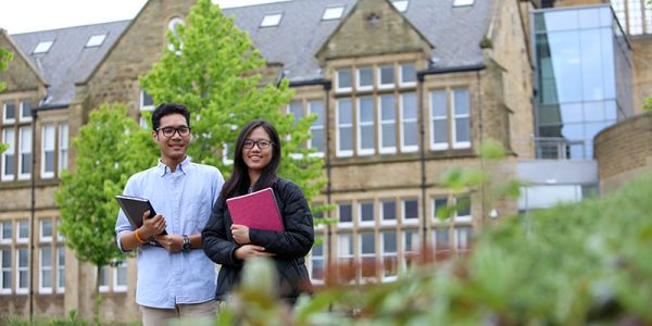 Masters students outside the Business School