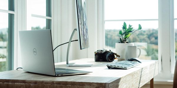 Home working desk set-up with computer and lots of natural light