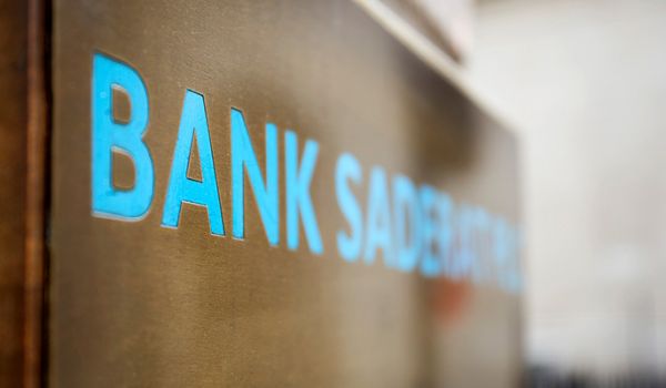 A close up of blue signage saying the word 'BANK'