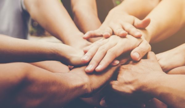 overlapping hands of several people