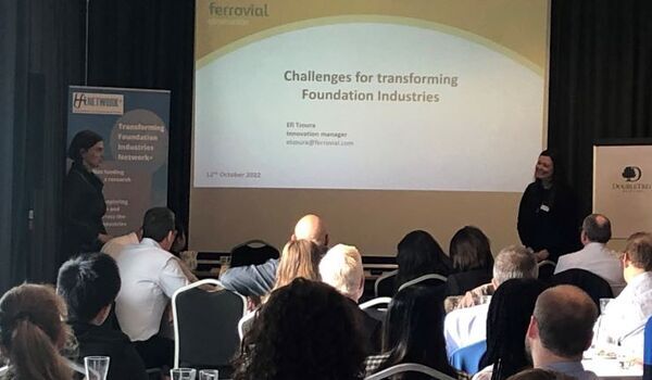 Professor Vera Trappmann and Professor Susan Bernal stood in front of a presentation on Challenges for transforming Foundation Industries, in front of an audience.