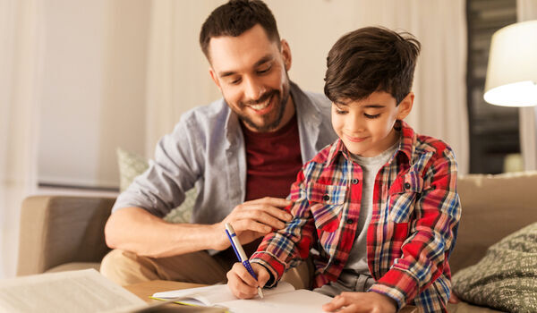 Father helping son with school work