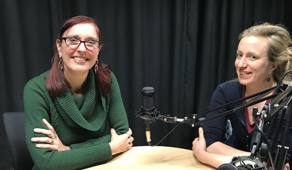Wandi Bruine de Bruin and Astrid Kause sat at a table with microphones