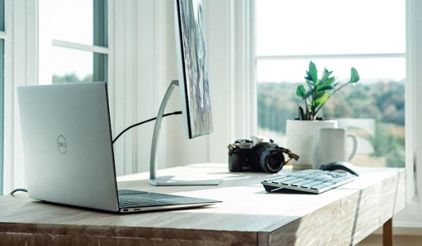 Home working desk set-up with computer and lots of natural light