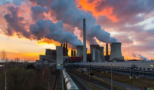 Image of a factory with smoking chimneys