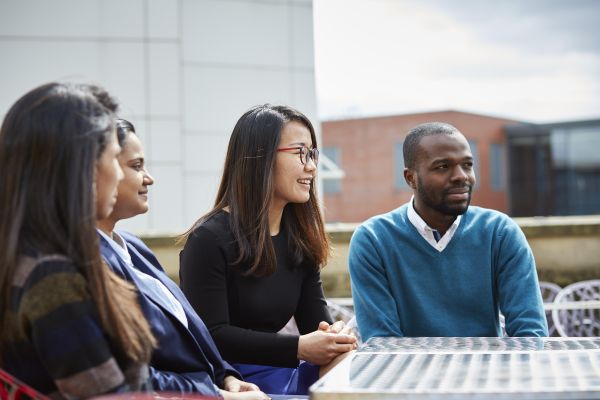 Group of MBA students with buildings in background