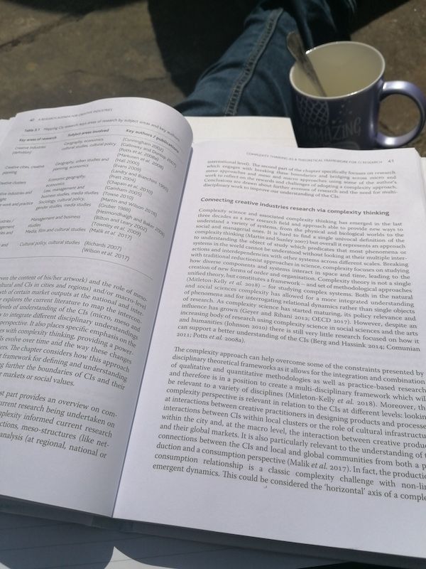 Open book with a cup next to it
