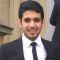 Bader in a busy location on campus wearing a suit