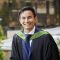 Damien Lee standing on the balcony of the Maurice Keyworth building on his graduation day.