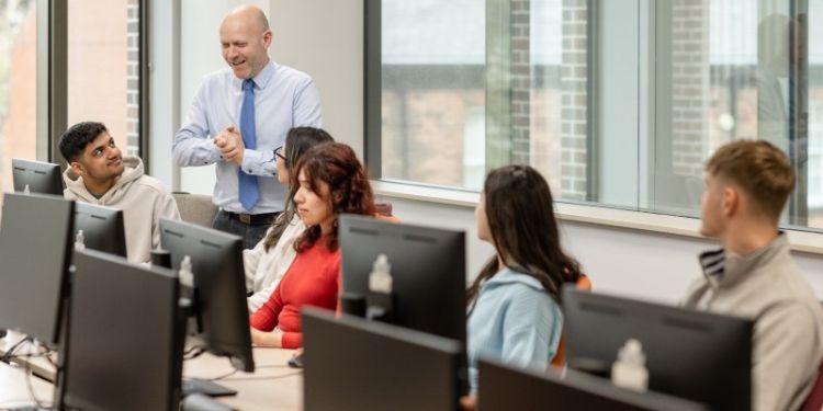 Students sat in IT cluster in the Esther Simpson Building being taught by a lecturer.