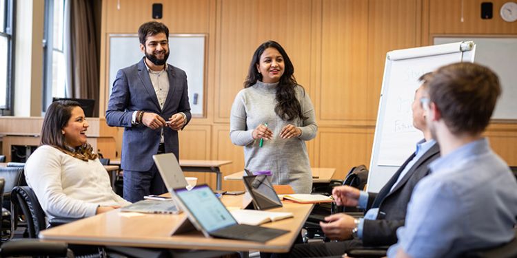 MBA students working on a group project in the boardroom