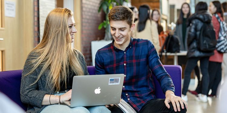 Two students working in the Charles Thackrah in front of the cafe