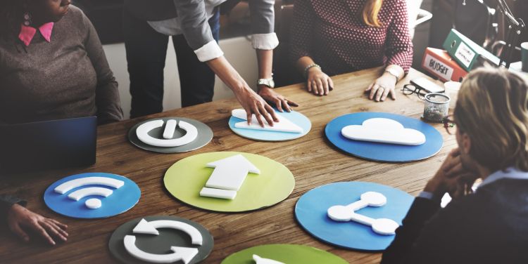 Office workers moving symbols around a desk