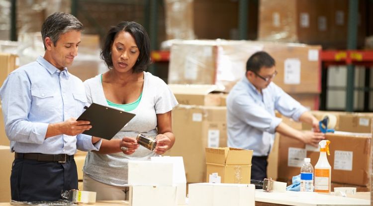Man and woman looking at a clipboard in a factory