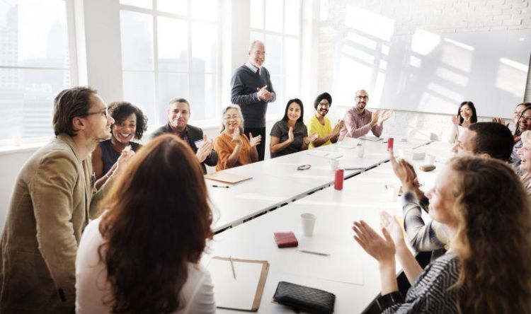 Colleagues sat around a boardroom table